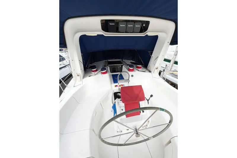 Slide: The Image of Cockpit of 1996 Hunter 430 sailboat with steering wheel and blue canopy. - 6