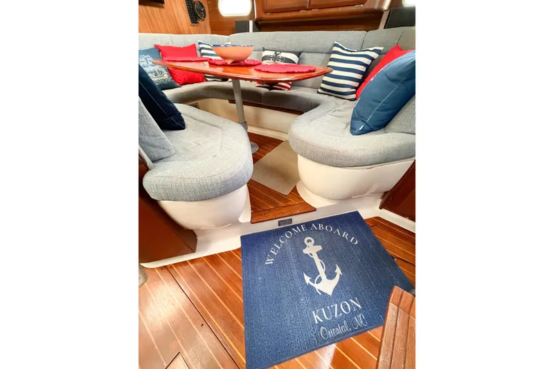 Slide: The Image of Cozy interior of 1996 Hunter 430 sailboat with nautical-themed decor and welcome mat. - 65