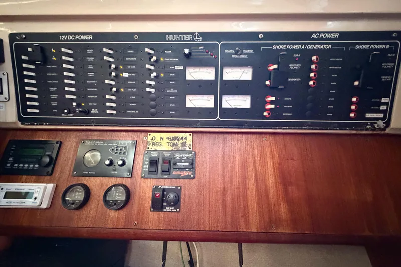 Slide: The Image of Electrical control panel of a 1996 Hunter 430 sailboat, featuring AC and DC power switches. - 66