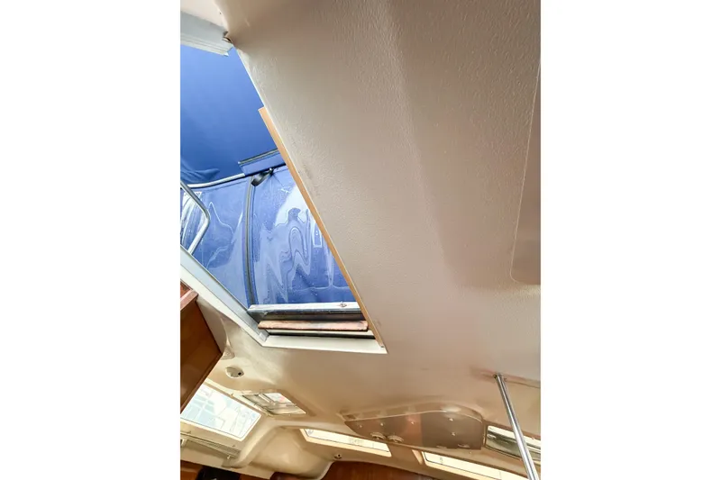 Slide: The Image of Interior view of a 1996 Hunter 430 sailboat with open hatch and blue canopy. - 67