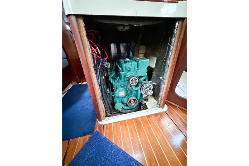 Slide: The Image of Engine compartment of a 1996 Hunter 430 sailboat, featuring a green marine engine. - 68