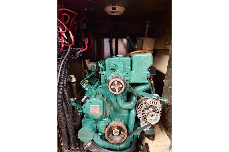 Slide: The Image of Engine compartment of a 1996 Hunter 430 sailboat, featuring a green marine engine. - 70