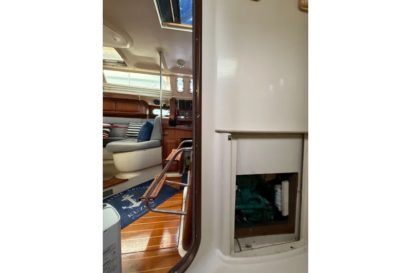 Slide: The Image of Interior of 1996 Hunter 430 sailboat showing seating area and engine compartment. - 72