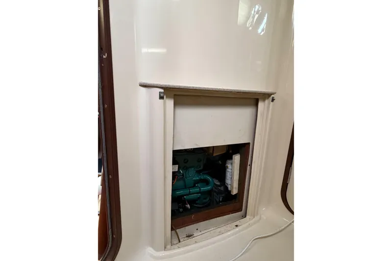 Slide: The Image of Engine compartment of a 1996 Hunter 430 sailboat, showcasing interior access panel. - 73