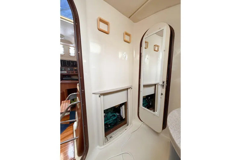Slide: The Image of Interior of a 1996 Hunter 430 sailboat showing engine access and cabin details. - 74