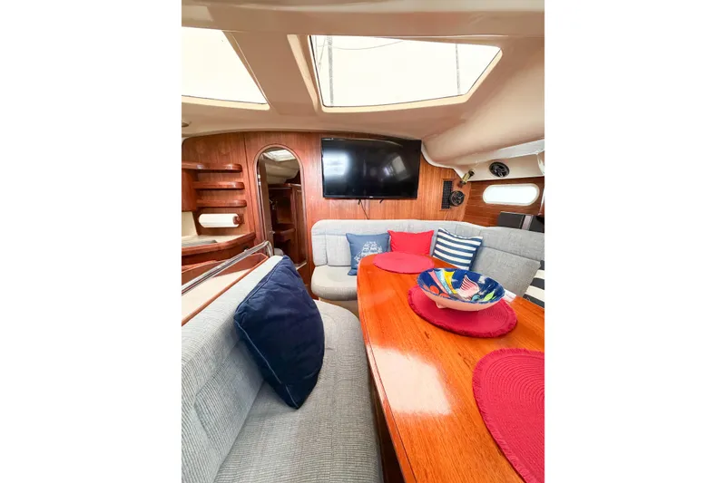 Slide: The Image of Interior of a 1996 Hunter 430 yacht with cozy seating and vibrant decor. - 77