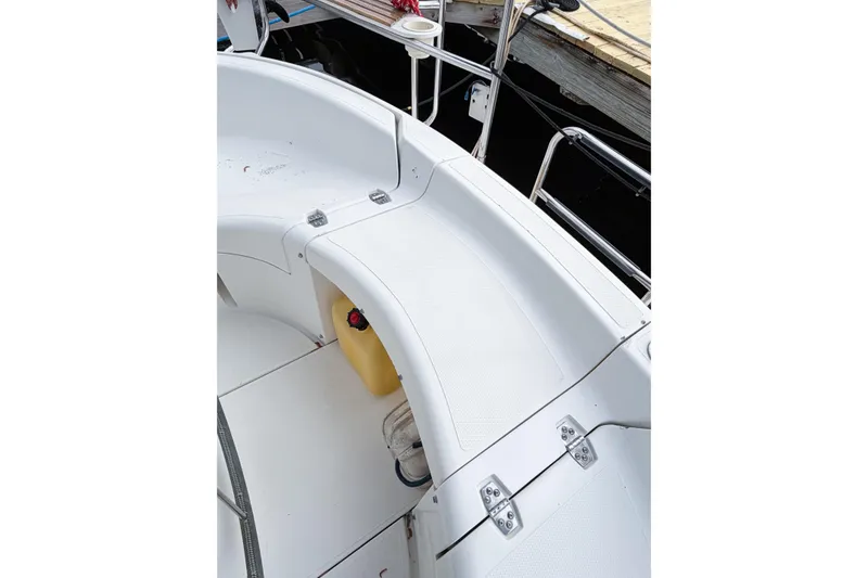 Slide: The Image of White deck of a 1996 Hunter 430 sailboat, featuring clean seating and railing. - 84