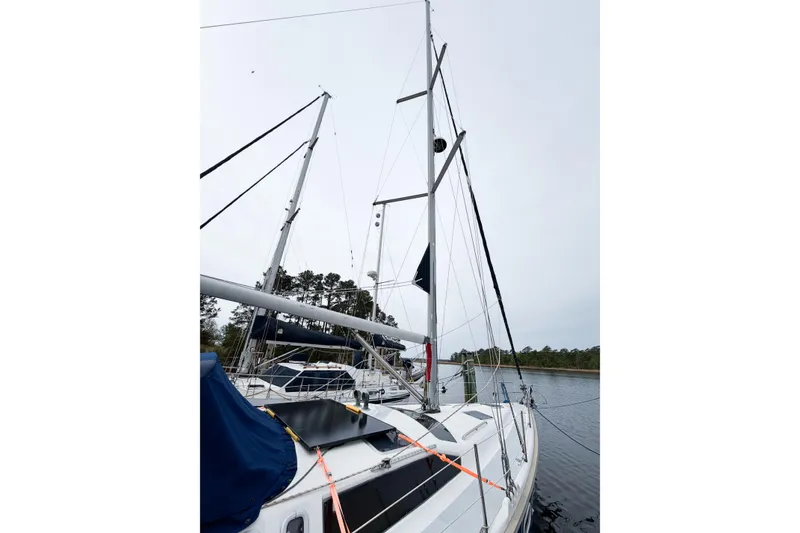 Slide: The Image of Sailboat Hunter 430, 1996 model, docked with tall mast and rigging. - 88