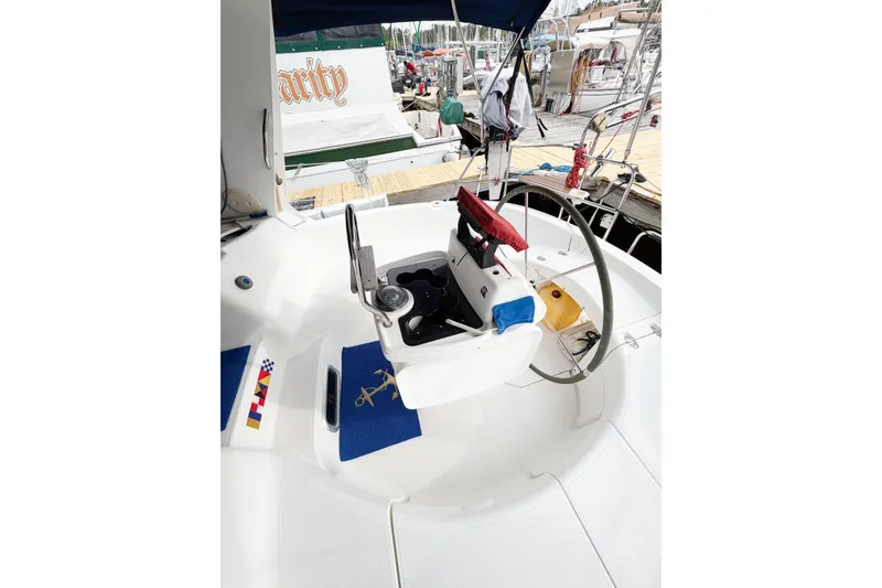 Slide: The Image of Cockpit of a 1996 Hunter 430 sailboat with steering wheel and nautical decor. - 9