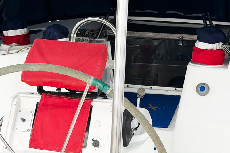 Slide: The Image of Interior view of a 1996 Hunter 430 sailboat cockpit with red and blue accents. - 90