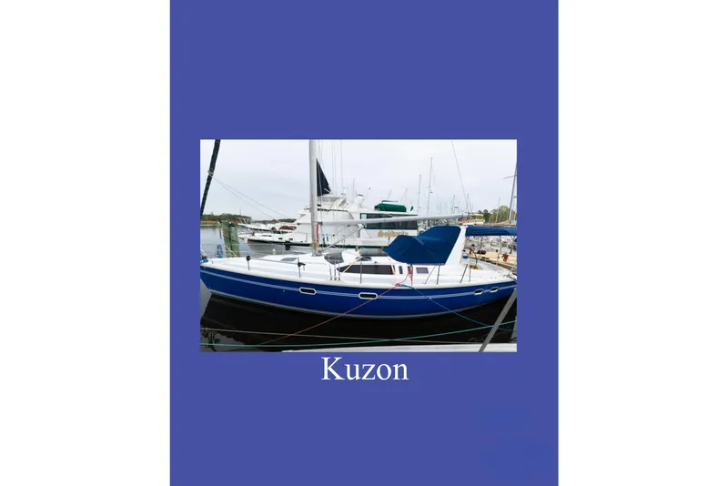 Slide: The Image of Hunter 430 sailboat from 1996, docked in a marina, named Kuzon. - 92
