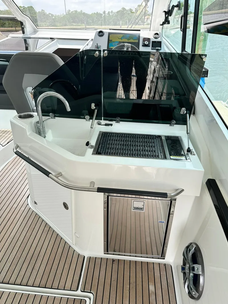 Slide: The Image of 2021 Beneteau GT 32 yacht kitchenette with sink and grill on teak deck. - 27