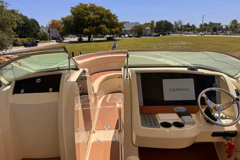 Slide: The Image of 2018 Chris-Craft Calypso 30 boat interior with Garmin navigation system and elegant dashboard. - 12