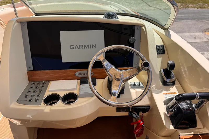 Slide: The Image of 2018 Chris-Craft Calypso 30 helm with Garmin display and steering wheel. - 13