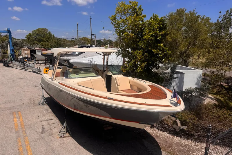 Slide: The Image of 2018 Chris-Craft Calypso 30 boat on land, surrounded by trees and equipment. - 3