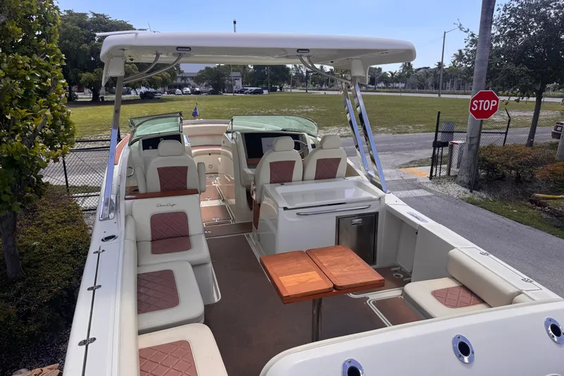 Slide: The Image of 2018 Chris-Craft Calypso 30 boat interior with seating and wooden table. - 5