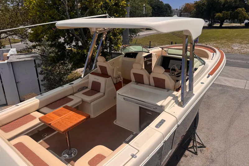 Slide: The Image of 2018 Chris-Craft Calypso 30 boat with elegant seating and wooden accents. - 6