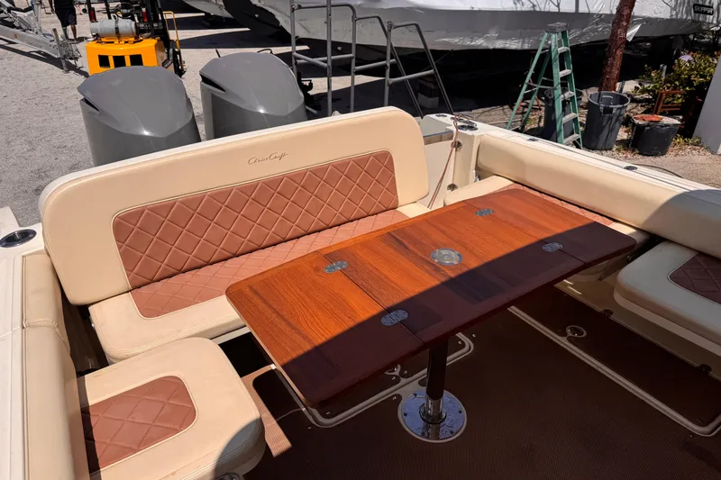 Slide: The Image of 2018 Chris-Craft Calypso 30 boat interior with elegant seating and wooden table. - 8