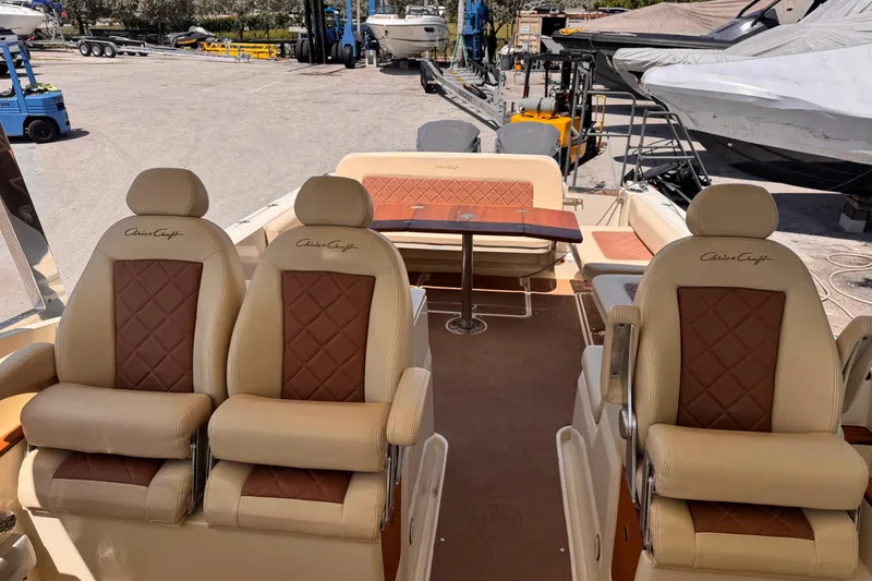 Slide: The Image of 2018 Chris-Craft Calypso 30 boat interior with luxurious seating and table. - 9