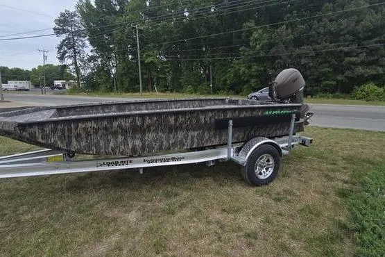 Slide: The Image of 2026 Havoc 1760 VJST boat on trailer, parked on grass near road. - 3