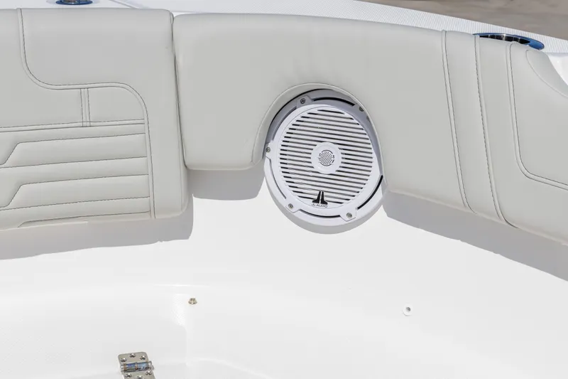 Slide: The Image of 2026 Edgewater 248CX Crossover boat interior with speaker and cushioned seating. - 10