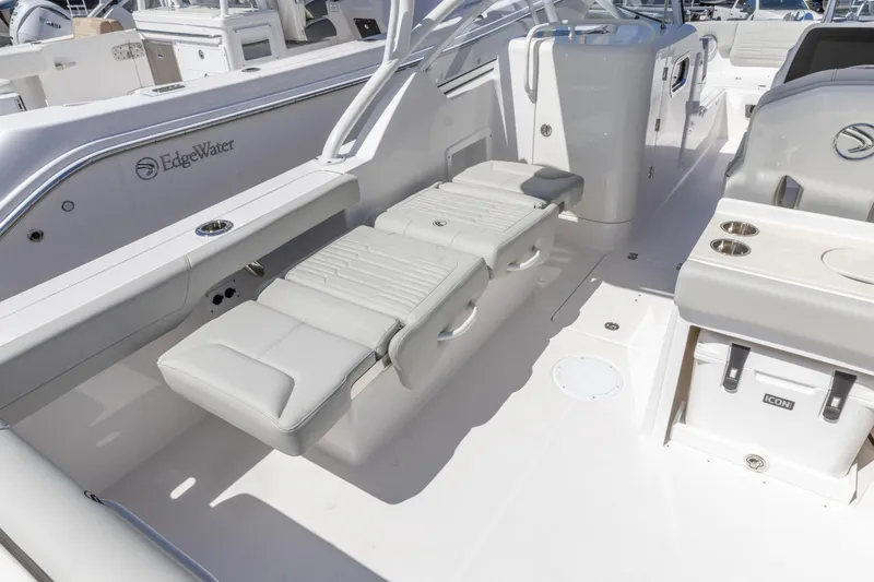 Slide: The Image of 2026 Edgewater 248CX Crossover boat interior with seating and storage features. - 12
