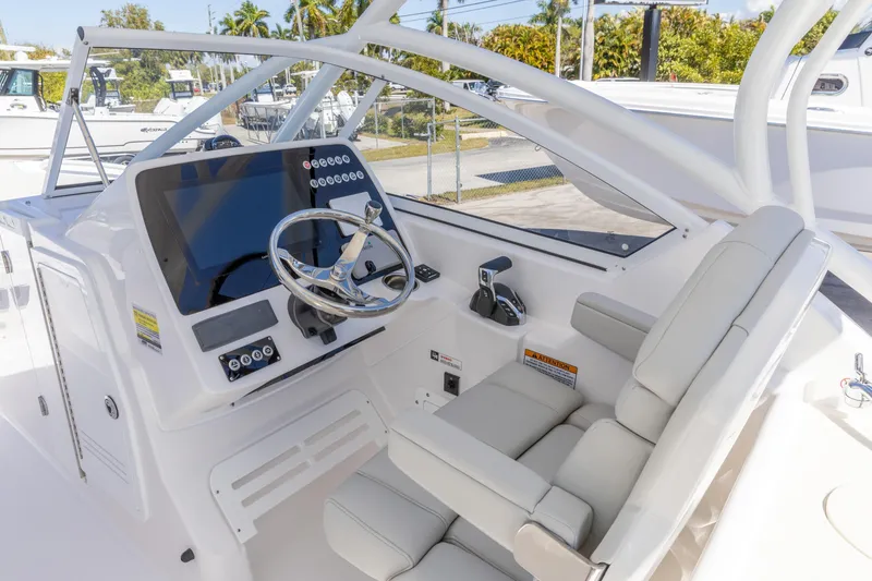 Slide: The Image of 2026 Edgewater 248CX Crossover boat cockpit with modern steering and controls. - 14