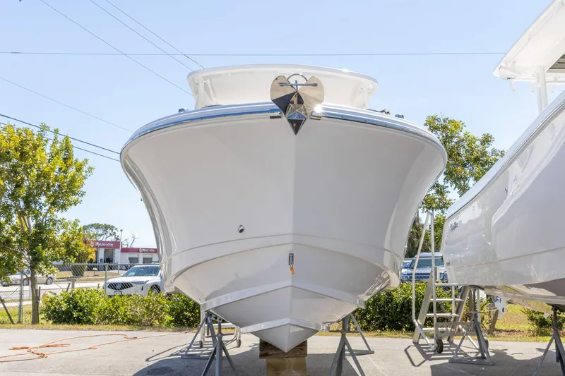 Slide: The Image of 2026 Edgewater 248CX Crossover boat on display, front view, outdoors. - 17