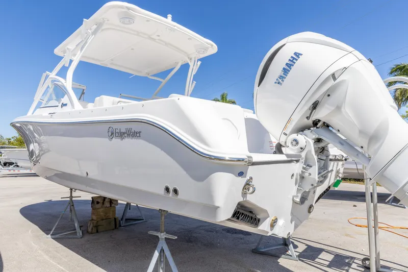 Slide: The Image of 2026 Edgewater 248CX Crossover boat with Yamaha engine, displayed outdoors. - 18
