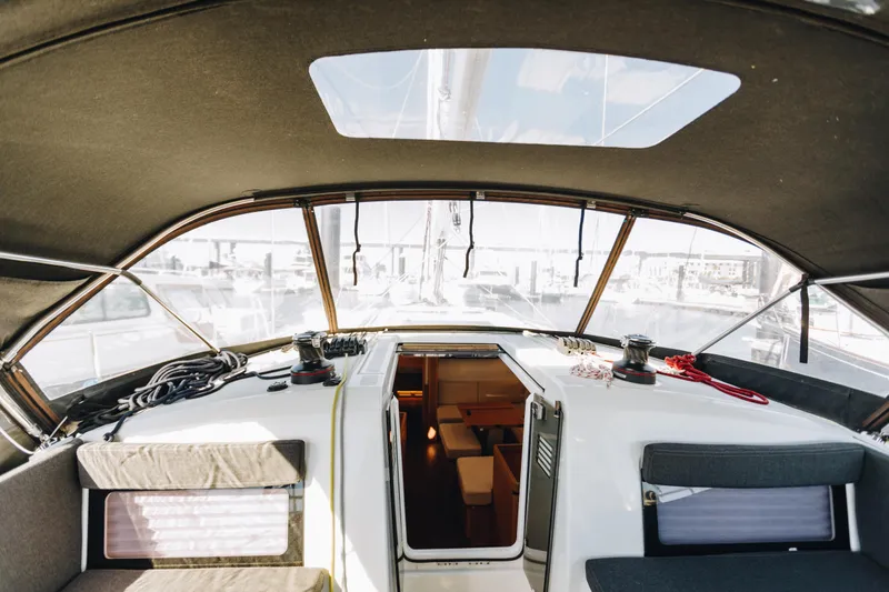 Slide: The Image of 2023 Jeanneau Sun Odyssey 490 yacht cockpit with open cabin view. - 10