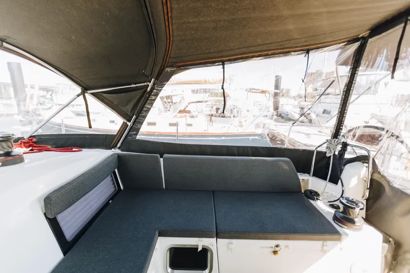 Slide: The Image of 2023 Jeanneau Sun Odyssey 490 cockpit with cushioned seating and protective canopy. - 11