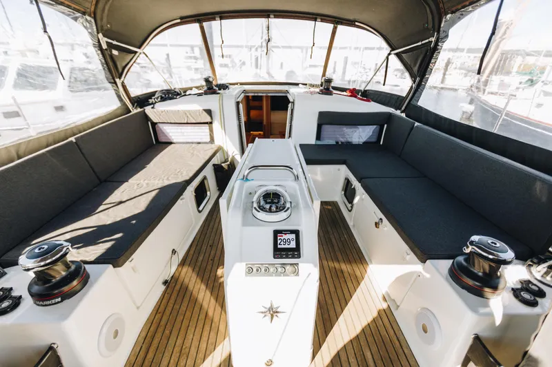 Slide: The Image of Interior view of 2023 Jeanneau Sun Odyssey 490 sailboat cockpit with seating and navigation equipment. - 12