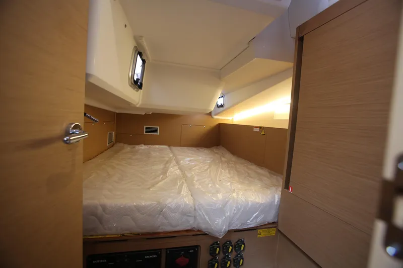 Slide: The Image of Cabin interior of 2023 Jeanneau Sun Odyssey 490 yacht with bed and wooden finish. - 27