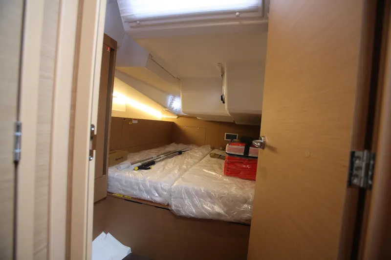 Slide: The Image of Interior cabin of 2023 Jeanneau Sun Odyssey 490 yacht, featuring modern design and storage. - 28