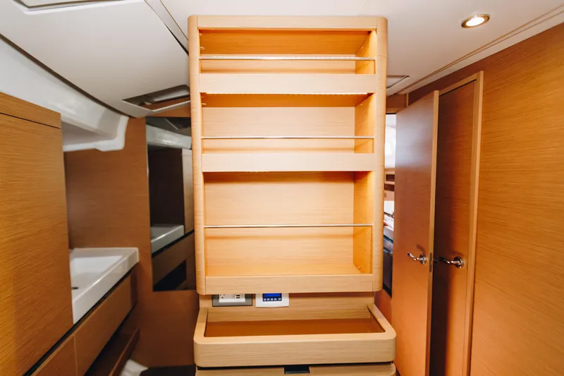 Slide: The Image of Interior of 2023 Jeanneau Sun Odyssey 490 yacht with wooden cabinetry and shelving. - 32