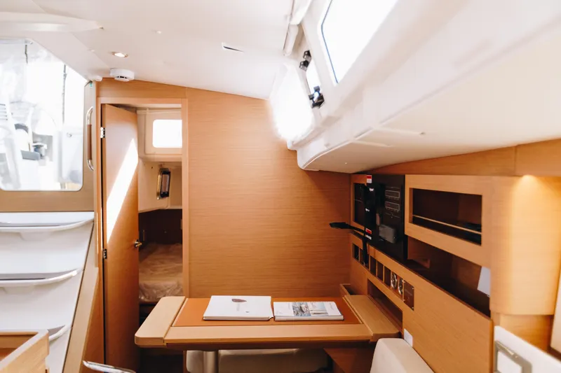Slide: The Image of Interior of 2023 Jeanneau Sun Odyssey 490 yacht, featuring modern wood finishes and ample natural light. - 36