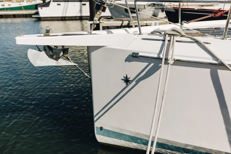 Slide: The Image of Jeanneau Sun Odyssey 490 yacht, 2023 model, docked with anchor and ropes visible. - 5