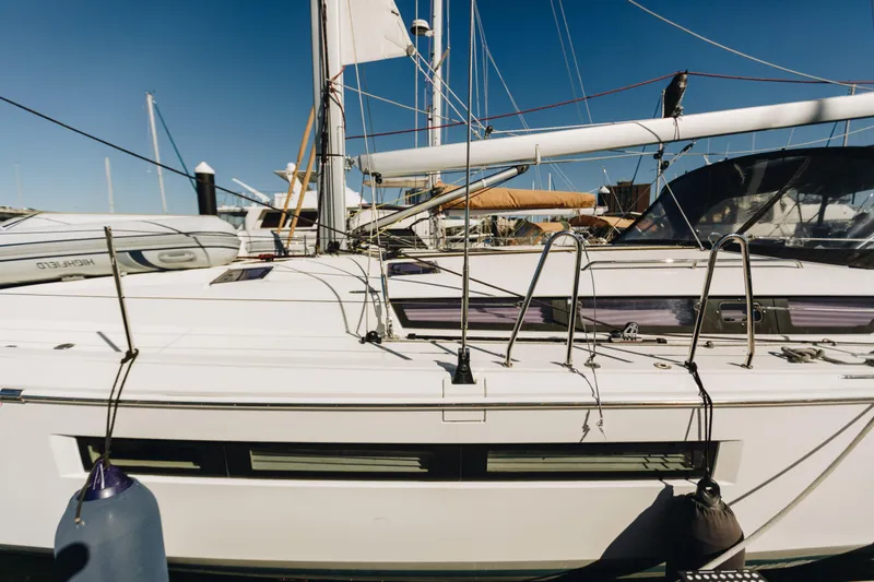 Slide: The Image of 2023 Jeanneau Sun Odyssey 490 sailboat docked at marina under clear blue sky. - 7