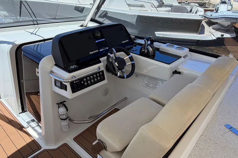 Slide: The Image of Helm of 2018 Aquila 36 Sport boat with modern controls and seating. - 4