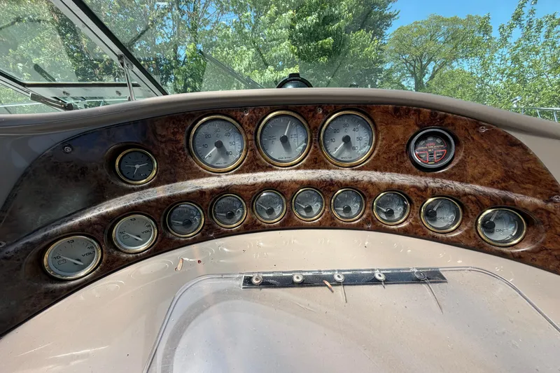 Slide: The Image of Dashboard of a 2003 Four Winns 328 Vista boat with multiple gauges. - 10