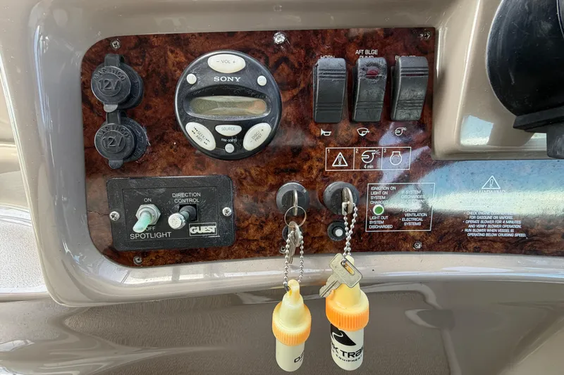 Slide: The Image of Control panel of a 2003 Four Winns 328 Vista boat with switches and keys. - 11