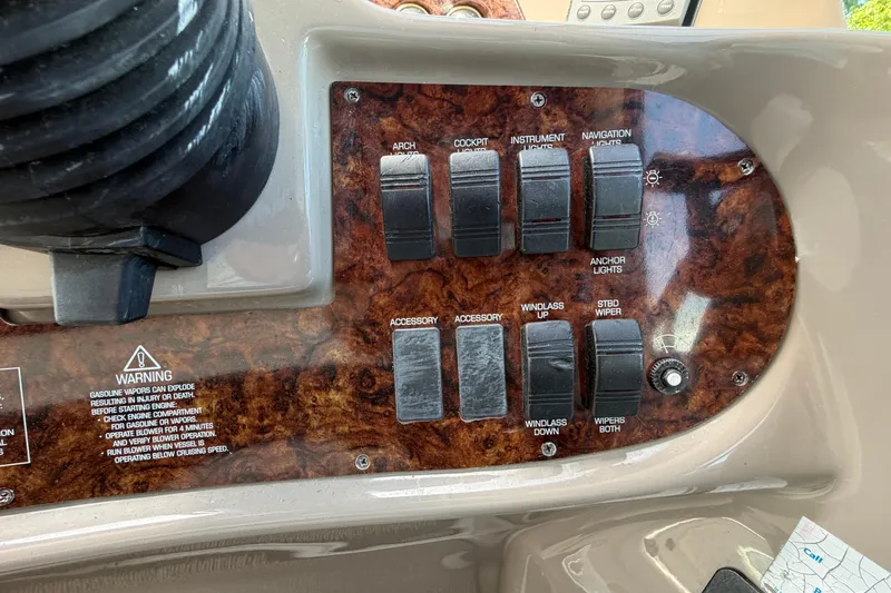 Slide: The Image of Control panel of a 2003 Four Winns 328 Vista boat with various switches. - 12