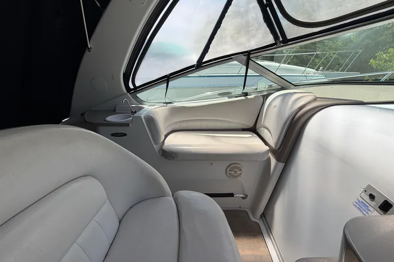 Slide: The Image of Interior of 2003 Four Winns 328 Vista boat with white seating and windows. - 13