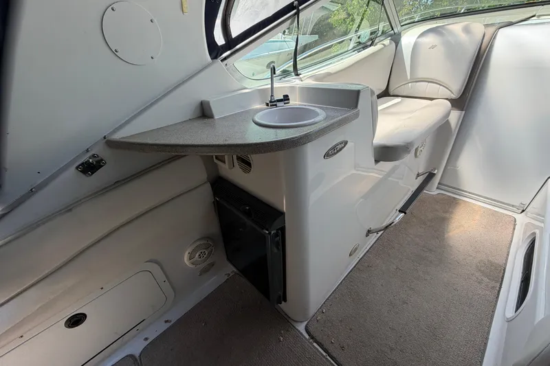 Slide: The Image of Interior of 2003 Four Winns 328 Vista boat with sink and seating area. - 14