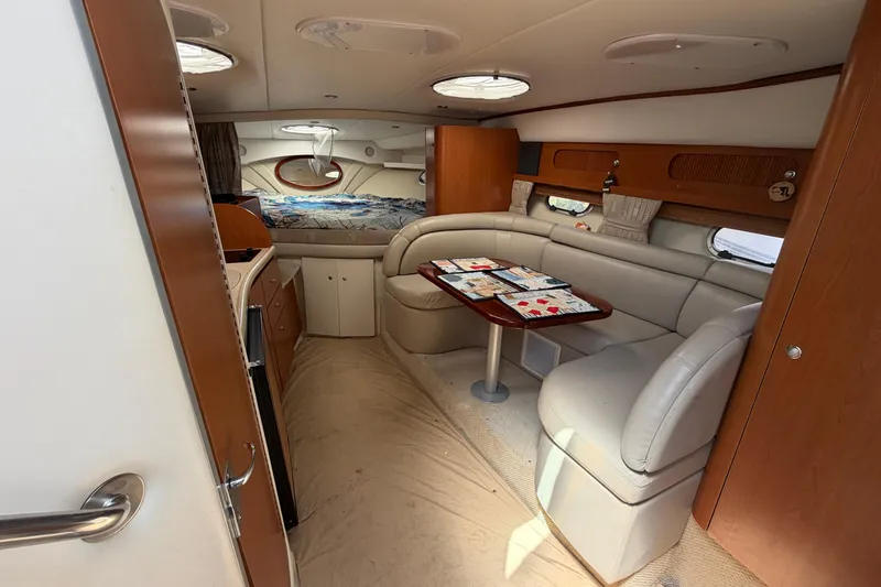 Slide: The Image of Interior of 2003 Four Winns 328 Vista yacht with cozy seating and dining area. - 15