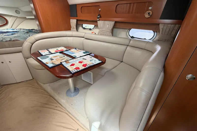 Slide: The Image of Interior of 2003 Four Winns 328 Vista boat with cozy seating and table. - 17