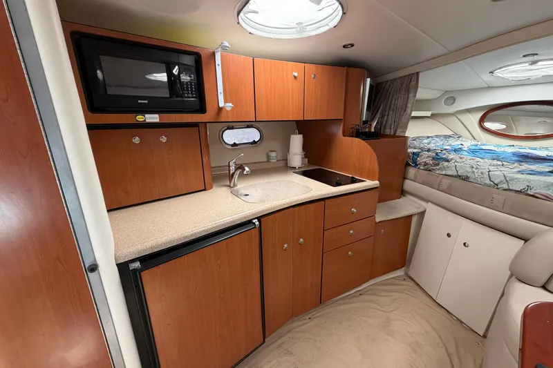 Slide: The Image of 2003 Four Winns 328 Vista boat interior with kitchenette and bed. - 18