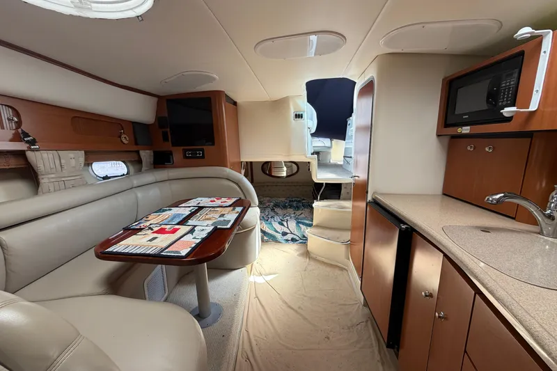 Slide: The Image of Interior of 2003 Four Winns 328 Vista boat with kitchenette and seating area. - 19