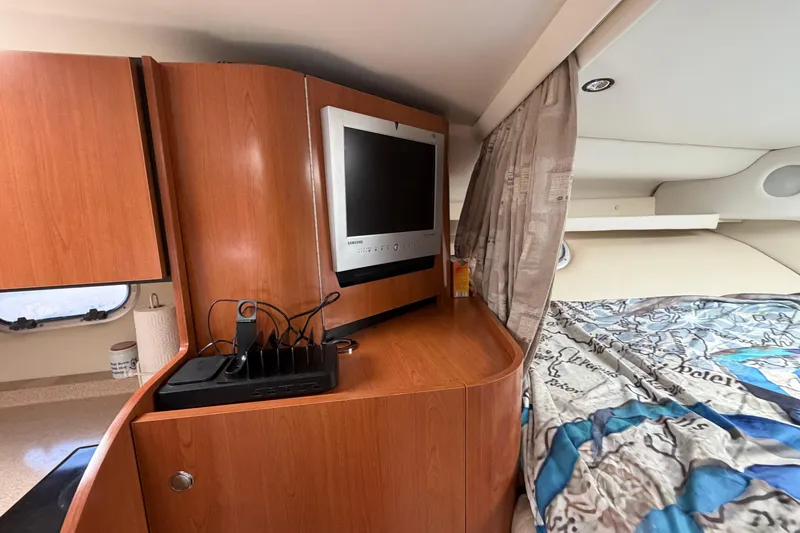 Slide: The Image of Interior of 2003 Four Winns 328 Vista boat with TV and cozy sleeping area. - 20