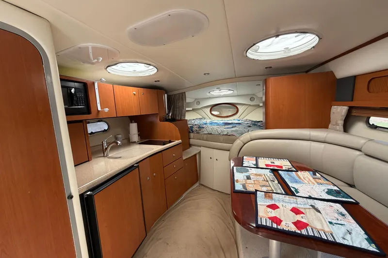 Slide: The Image of Interior of 2003 Four Winns 328 Vista boat with kitchenette and seating area. - 21